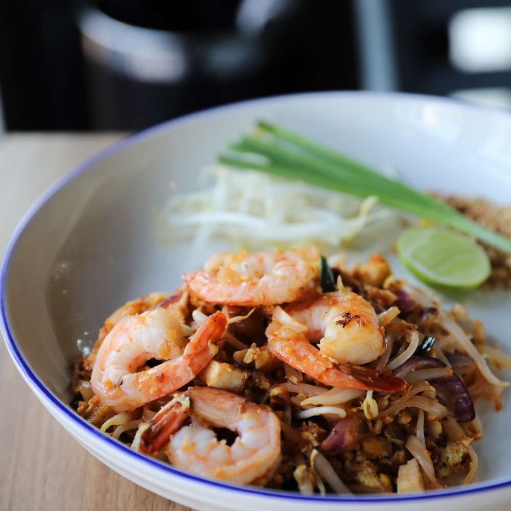 Pad thai with shrimp thai food wood background