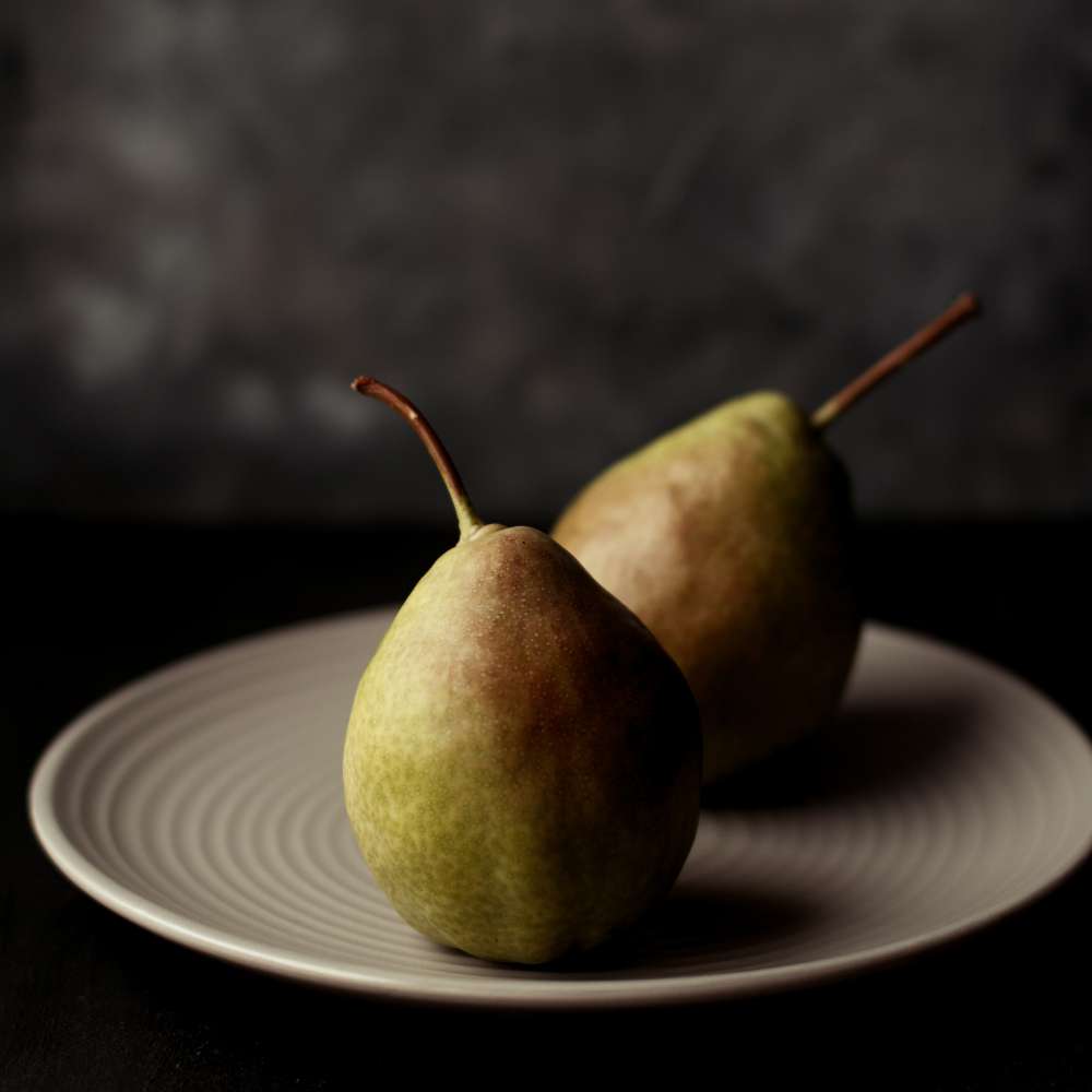 Vertical selective closeup shot pears white plate