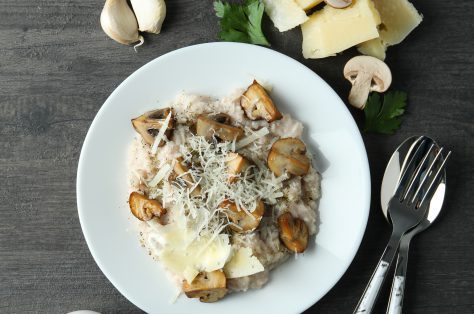 Concept tasty food with risotto with mushrooms dark wooden table